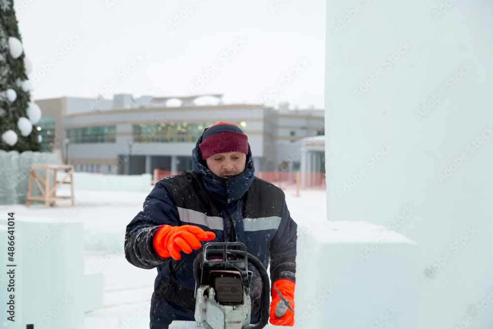 Portrait of an assembler with a chainsaw in his hands Portrait of an assembler with a chainsaw in his hands
