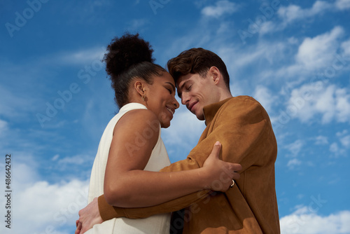 Couple hugging at a blue sky photo