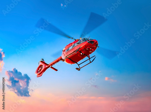 Helicopter. Air transportation. Air ambulance. Red color helicopter in the air. Great photo on the theme of air medical service, air transportation,  air ambulance,  fast city transportation photo
