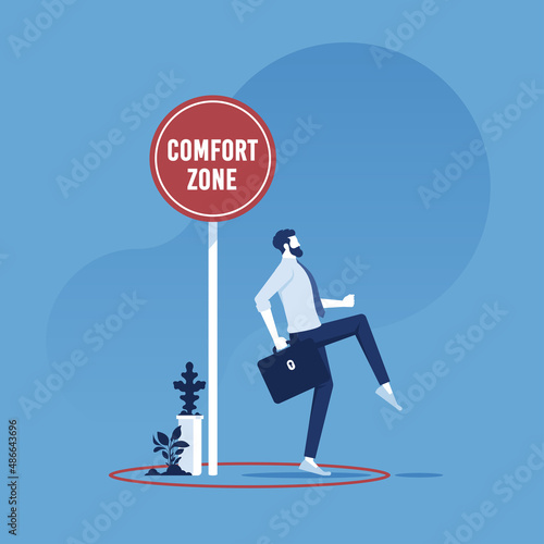 Exit from the comfort zone concept, businessman carefully stepping out of a comfort zone photo