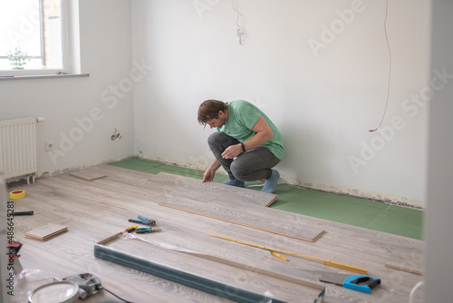 Male Renovation Master Laying Laminate Flooring