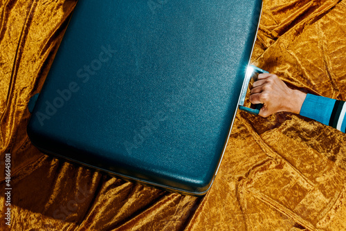 man with a retro blue suitcase