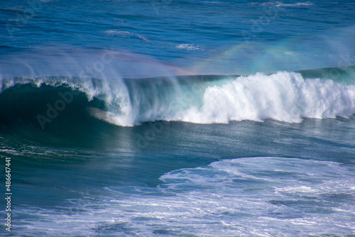 Rainbow colors in the spray above a wave