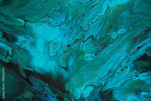 Fluid Art. Green and blue abstract wave swirls on black background. Marble effect background or texture © colnihko