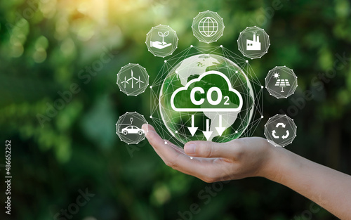 Reduce CO2 emission concept in the hand for environmental, global warming, Sustainable development and green business based on renewable energy. photo