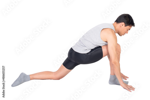 Determined sportsman stretching psoas muscle in studio