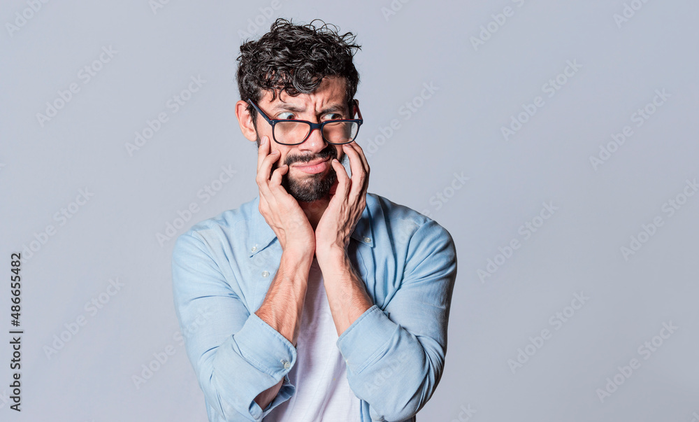 Puzzled man on isolated background, face of a puzzled and skeptical guy on isolated background Puzzled man on isolated background, face of a puzzled and skeptical guy on isolated background
