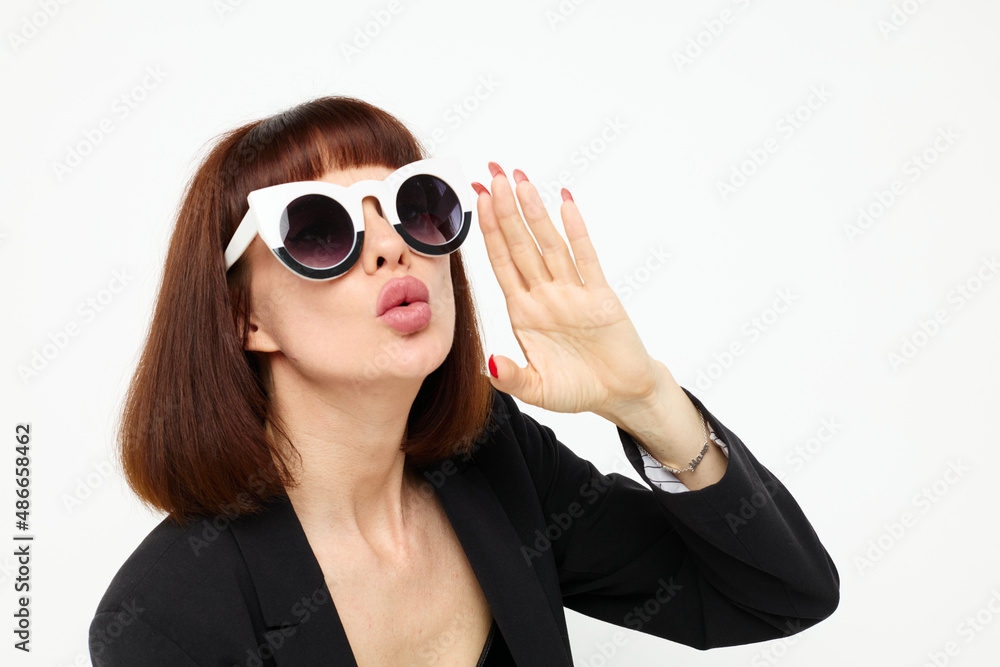 attractive woman in a black jacket red nail polish stylish sunglasses Lifestyle unaltered attractive woman in a black jacket red nail polish stylish sunglasses Lifestyle unaltered
