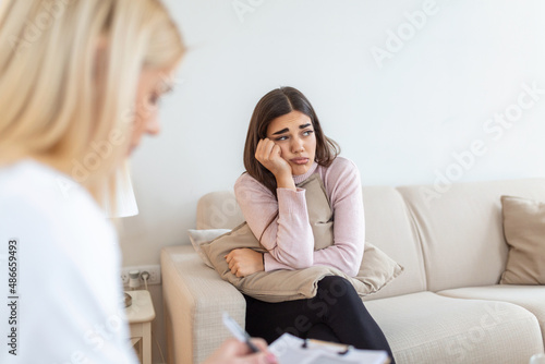 Psychologist listening to her patient and writing notes, mental health and counseling. Psychologist consulting and psychological therapy session concept