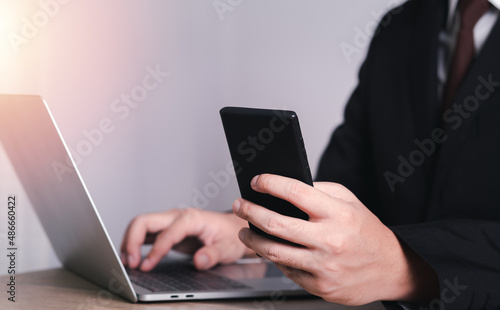 businessman is using a credit card with a smartphone for financial transactions. Online banking purchase product on internet in home office or online shopping. Convenience in the world of technology.