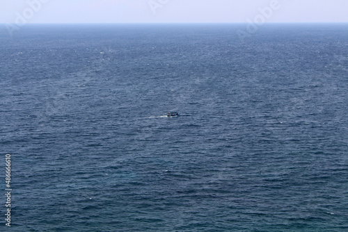 Small boat and horizon line of the Pacific ocean around Uluwatu. Taken January 2022. © leodaphne