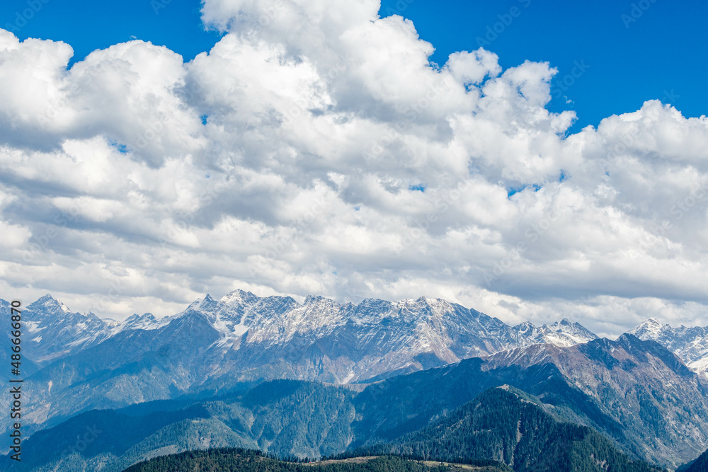 Blue Sky with full of White Clouds, and green trees, and the mountain is full of greeneries, a magical view of north Pakistan, Shogran National Park. 