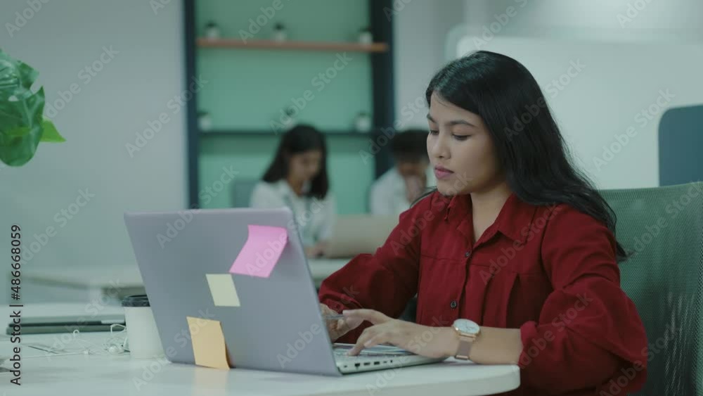 Young adult Indian business woman typing on laptop working in internet,beautiful female professional user lady using PC technology doing online job in office or browsing web site at office table. Young adult Indian business woman typing on laptop working in internet,beautiful female professional user lady using PC technology doing online job in office or browsing web site at office table.