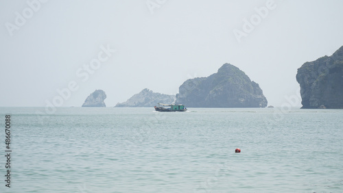 Ha Long Bay mountains rising out of the water in Vietnam. photo