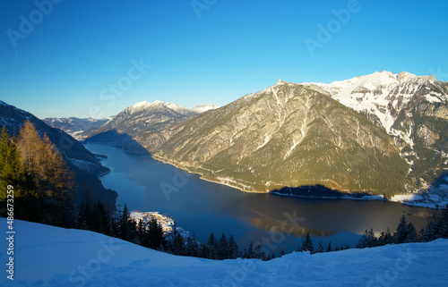 top view of the Achensee from a mountain top on a sunny winter day