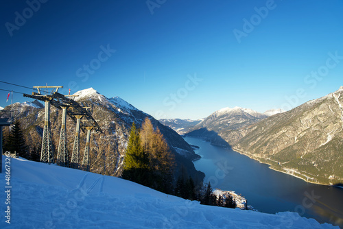 top view of the Achensee from a mountain top on a sunny winter day photo