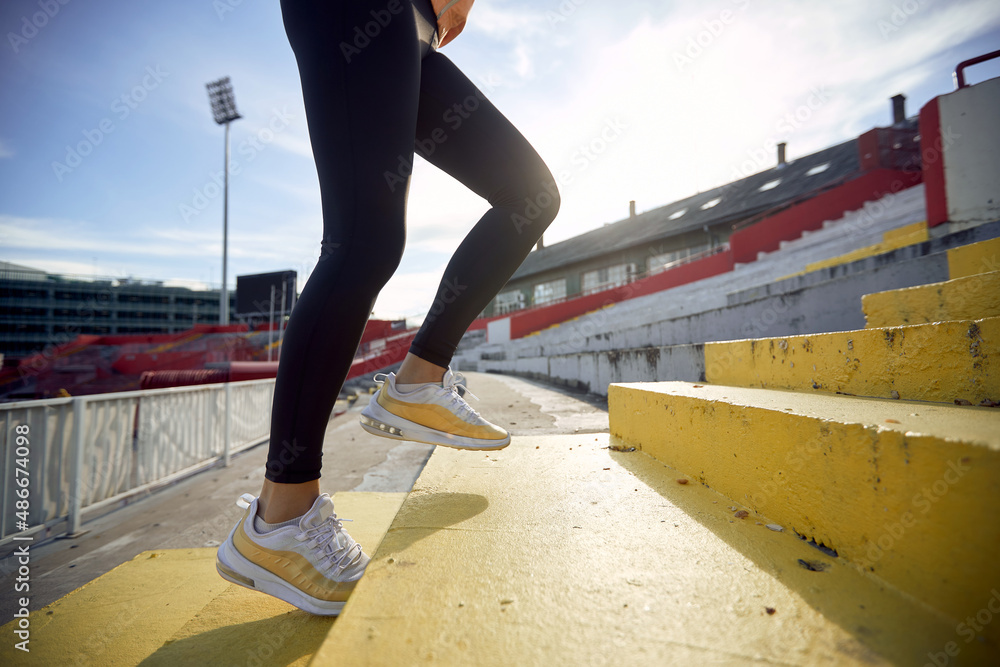 cropped image of female legs running up the concrete staircase. cropped image of female legs running up the concrete staircase.