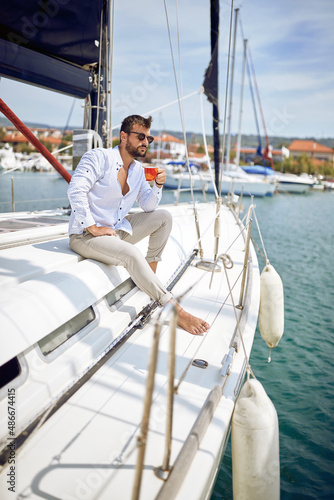 Casual charming man sailing alone
