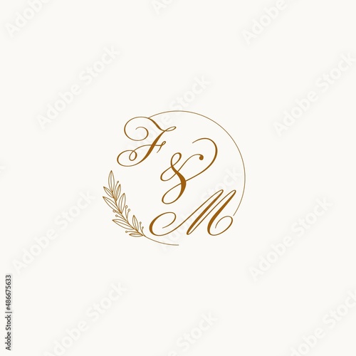 Initials FM wedding monogram logo with leaves and elegant circular lines