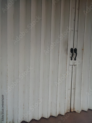Dull and rusty white folding door