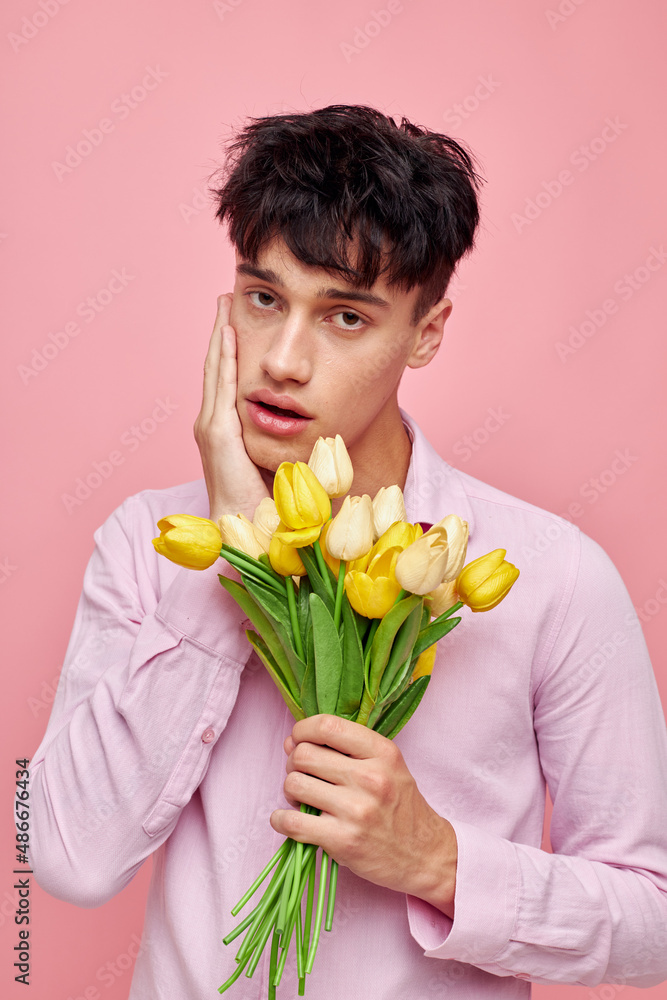 A young man Bouquet of yellow flowers romance posing fashion isolated background unaltered