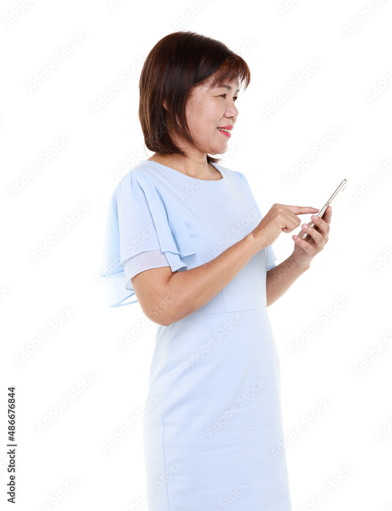Studio closeup cutout isolated shot of Asian friendly senior grandmother female model in casual outfit standing smiling holding smartphone mobile on white background. Studio closeup cutout isolated shot of Asian friendly senior grandmother female model in casual outfit standing smiling holding smartphone mobile on white background.