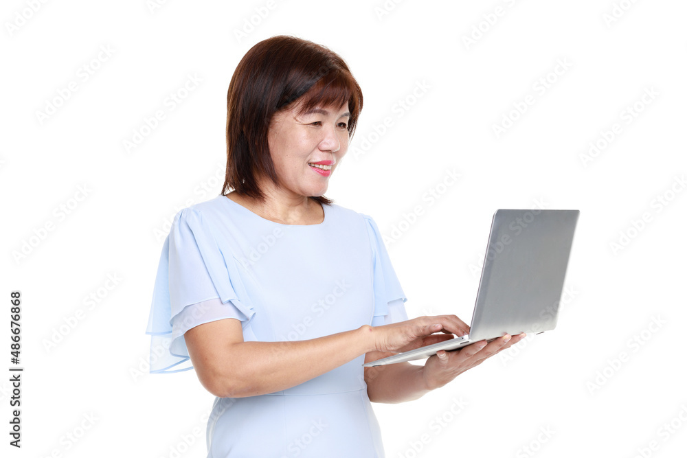 Studio closeup cutout isolated shot of Asian friendly senior grandmother female model in casual outfit standing smiling holding laptop computer typing surfing browsing internet on white background Studio closeup cutout isolated shot of Asian friendly senior grandmother female model in casual outfit standing smiling holding laptop computer typing surfing browsing internet on white background
