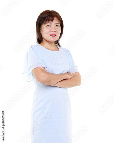 Studio closeup cutout isolated shot of Asian friendly senior grandmother female model in casual outfit standing smiling on white background. © Bangkok Click Studio