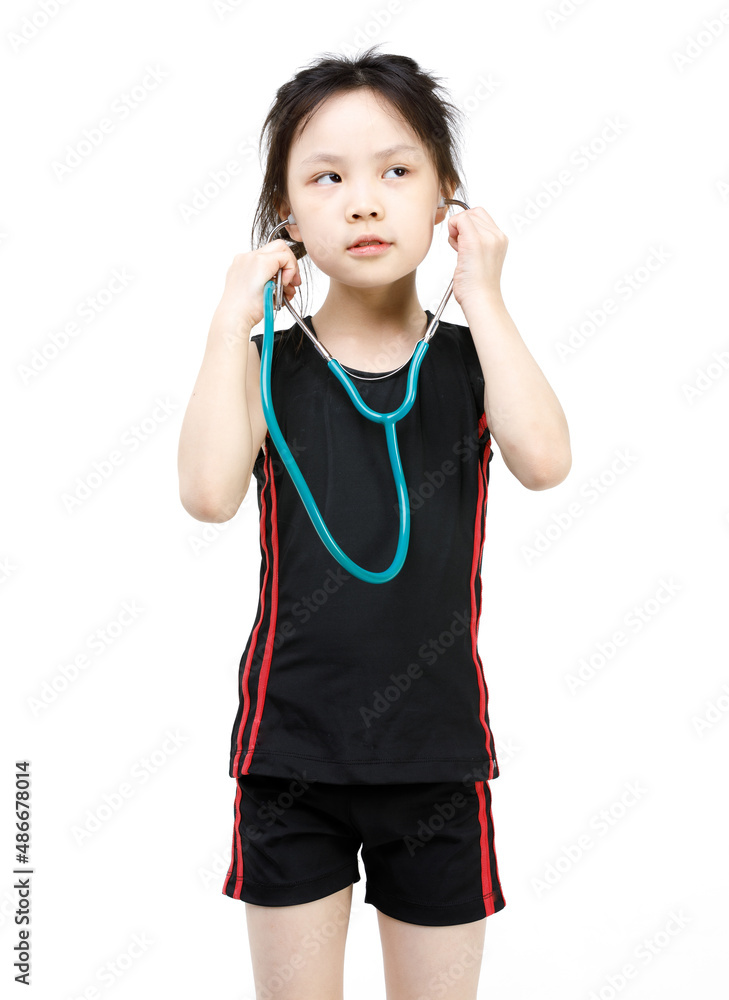 Portrait studio cutout isolated shot Asian little preschool girl in sport wears wearing holding stethoscope pretending as doctor role in hospital listening to patient heartbeat on white background