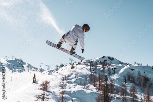 snowboarder jumping in the mountains