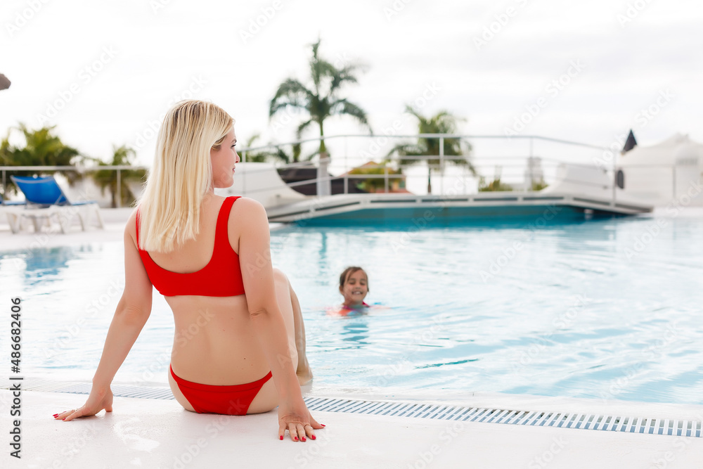 Summer in the city. Happy young woman near swimming pool