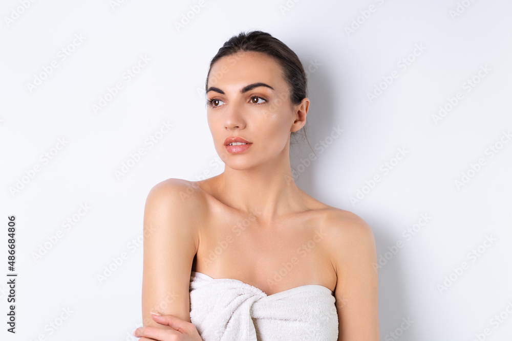 Close beauty portrait of a topless woman with perfect skin and natural make-up, plump nude lips, on a white background. Close beauty portrait of a topless woman with perfect skin and natural make-up, plump nude lips, on a white background.