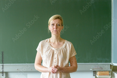 Thoughtful school teacher frowning in concentration photo