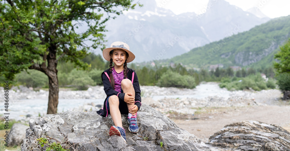 Portrait of a cute little girl in mountains.
