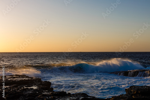 Evening scene on sea, stones, calm ocean