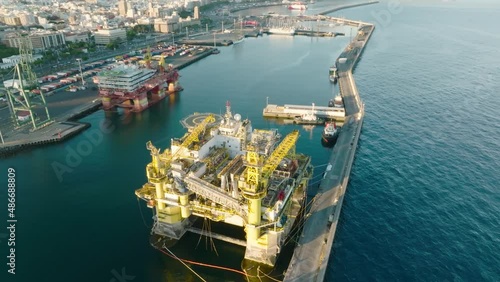 Drone flight over gas platform in the bay. Top view of gas platform in marina bay. Ecology balance in the Atlantic ocean. Nature energy resources under the shelf. photo