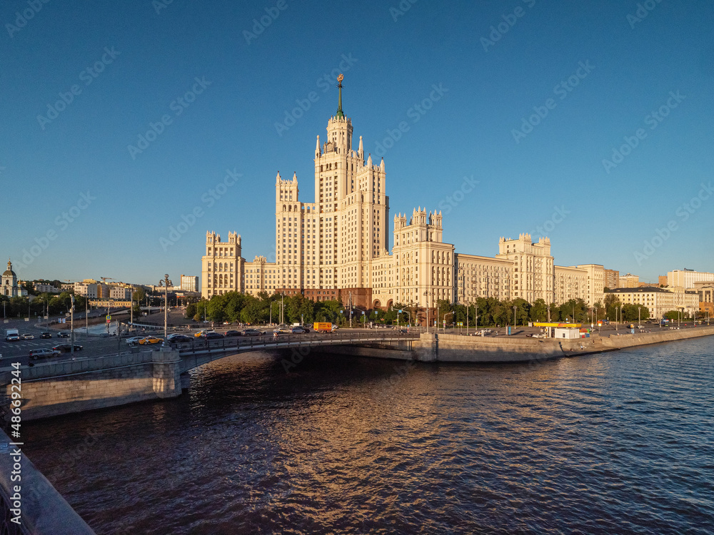 Moscow in summer. View of the city from the Bolshoy Ustinsky Bridge. A skyscraper on the Kotelnicheskaya embankment in the style of the Stalinist Empire. Moscow in summer. View of the city from the Bolshoy Ustinsky Bridge. A skyscraper on the Kotelnicheskaya embankment in the style of the Stalinist Empire.