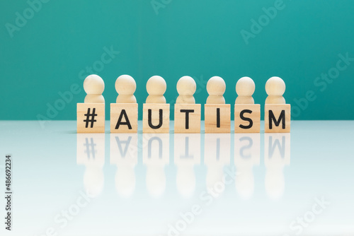 Concept of autism day ASD with with wooden figurines and letters
