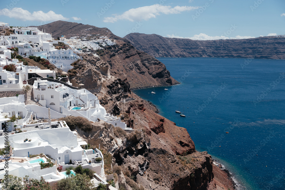 White architecture on Santorini island with view on the sea, Oia, Greece. Summer vacation and holiday concept, luxury travel. Wonderful scenery, cruise ships and white architecture. Amazing landscape.