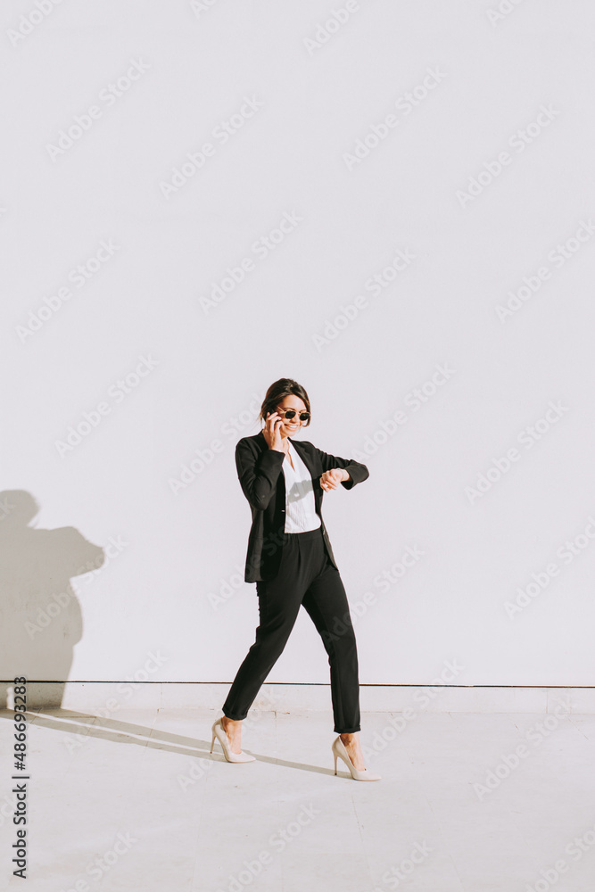 Fototapeta premium Young business salesperson woman selling and prospecting on the phone. Expert young and successful saleswoman building rapport with her client. Concept about salespeople and closing sales