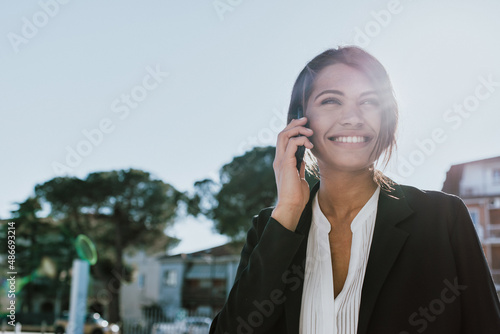 Young business salesperson woman selling and prospecting on the phone. Expert young and successful saleswoman building rapport with her client. Concept about salespeople and closing sales photo