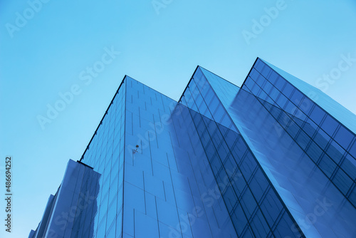 Looking Up Blue Modern Office Building. Building made of glass and metal