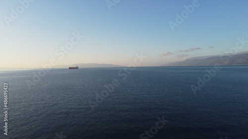 Aerial view of a big cargo ship sails on the open sea