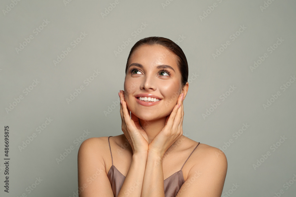 Healthy smiling spa model woman with clean skin looking up Healthy smiling spa model woman with clean skin looking up