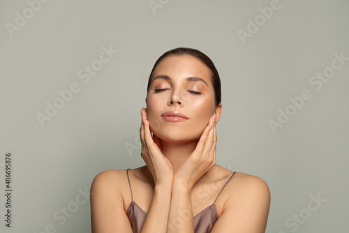 Attractive woman relaxing. Spa model with healthy skin and closed eyes