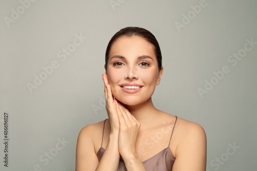 Beautiful young smiling woman spa model with clean fresh skin. Facial treatment and skincare concept .