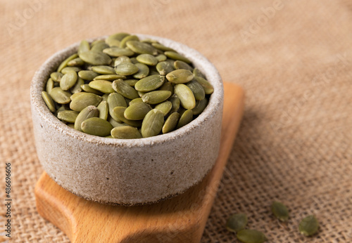 Pumpkin seeds in a bowl, superfoods. Copy space