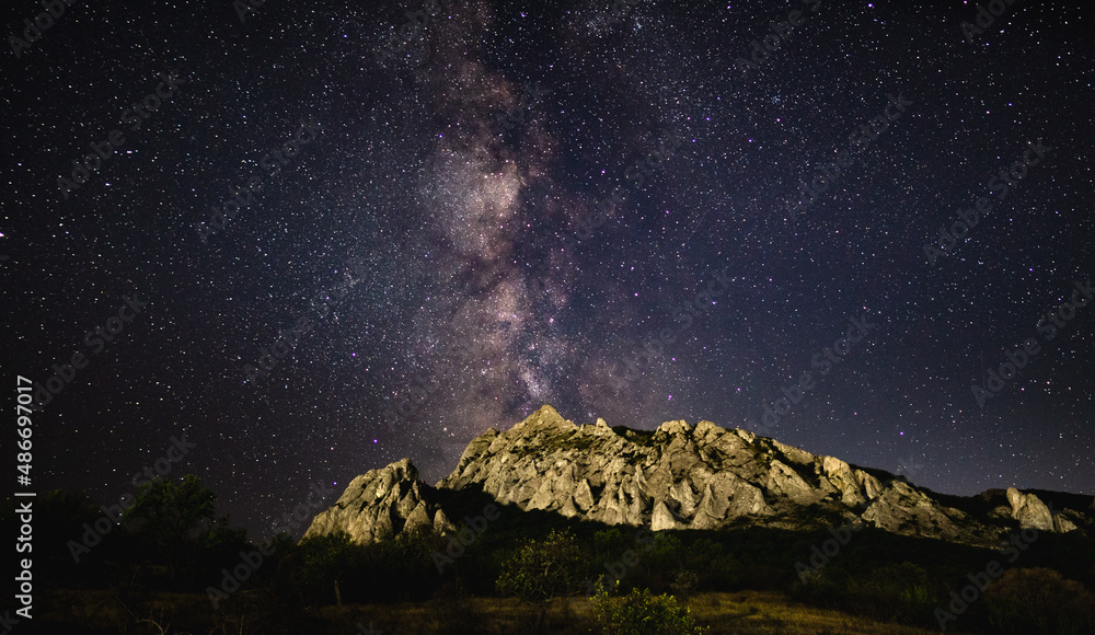 The Milky Way in the starry sky over the Karadag mountain range on a summer night. Delightful landscape. Astrophotography The Milky Way in the starry sky over the Karadag mountain range on a summer night. Delightful landscape. Astrophotography