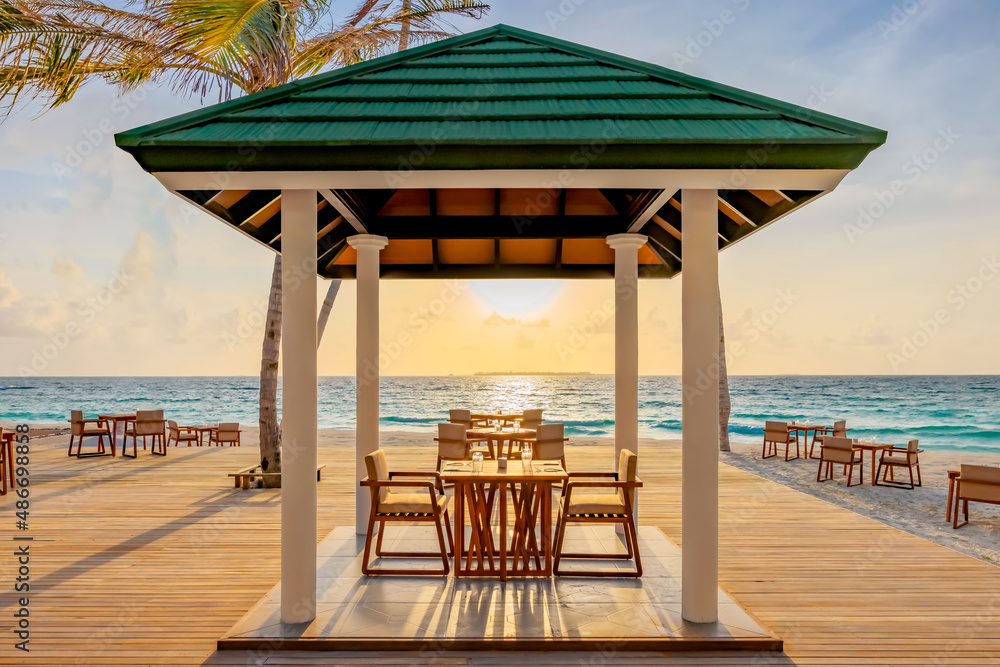 Beautiful Outdoor cafe with huts during the sunset sea view Sun Siyam world in maldives
