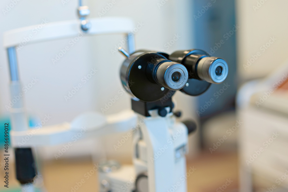 Checking the eye vision with modern optical equipment. Ophthalmology medical equipment. 